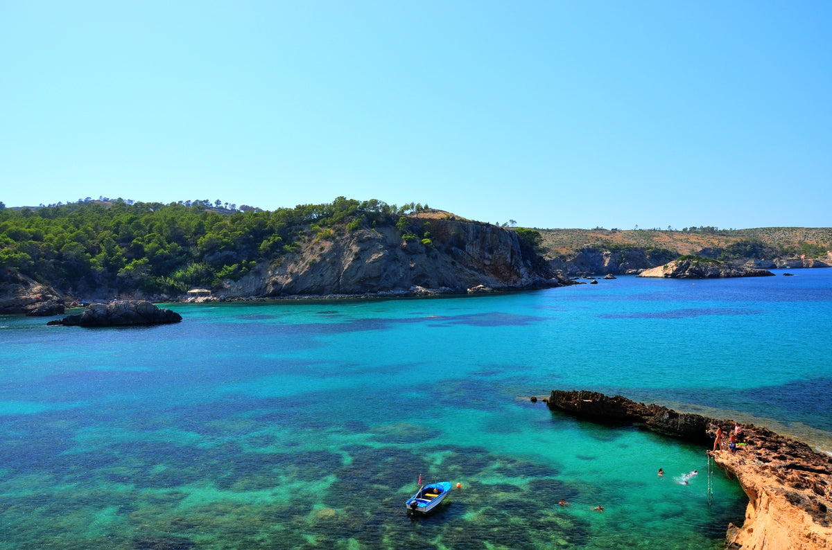 Cala Xarraca, the turquoise bay below the resort's clifftop setting in northern Ibiza