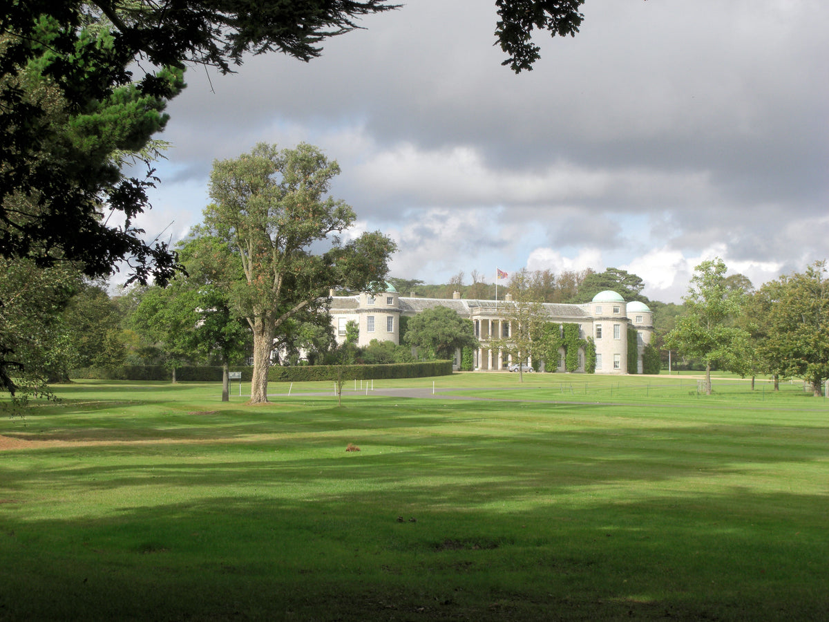 Goodwood House seen across open parkland on the Goodwood Estate