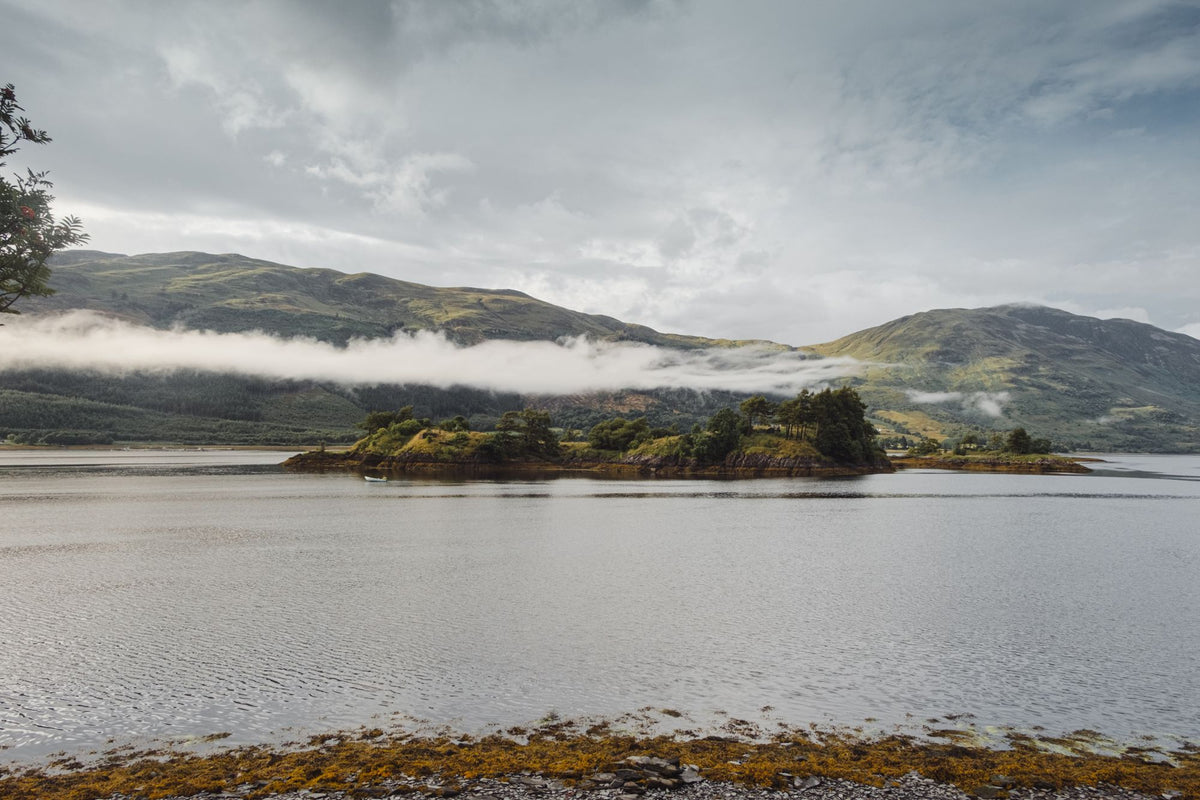 A misty Scottish loch and mountains
