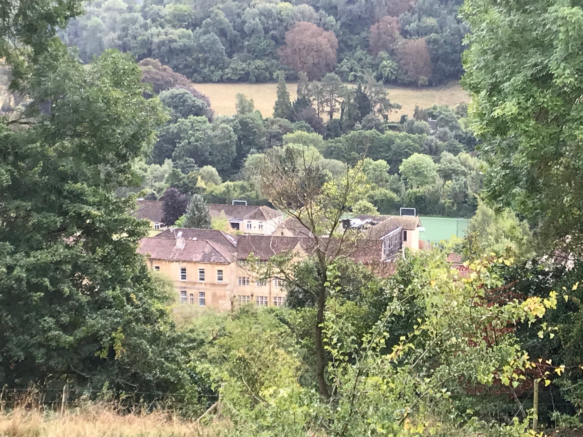 A house set among wooded hills in the Monkton Combe valley near Bath, the wider setting rather than Combe Grove itself