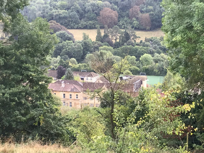 A house set among wooded hills in the Monkton Combe valley near Bath, the wider setting rather than Combe Grove itself