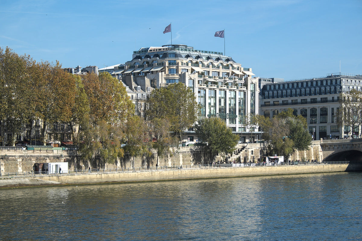 Cheval Blanc Paris in the former Samaritaine building, seen across the Seine in autumn sunshine beside the Pont Neuf