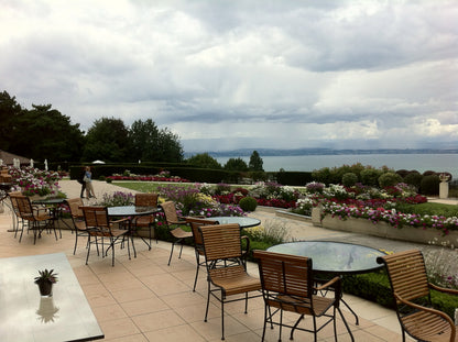 The terrace and gardens of Hôtel Royal, Évian Resort overlooking Lake Geneva