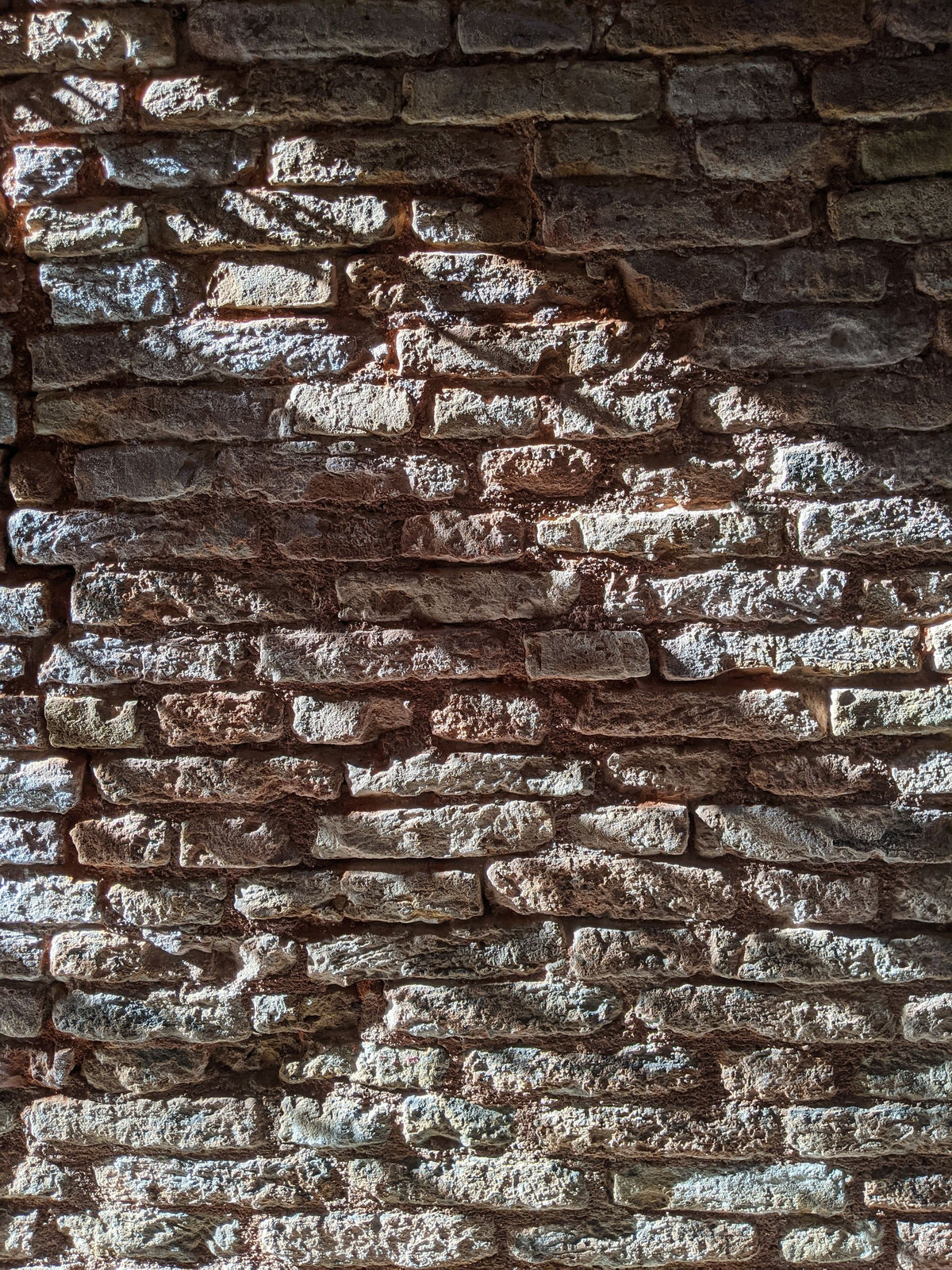 Close up of an old stone wall, the centuries old masonry the Bathhouse itself is built into