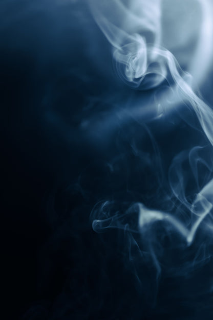 Pale smoke drifting through dark blue air, evoking the whole body cryotherapy chamber