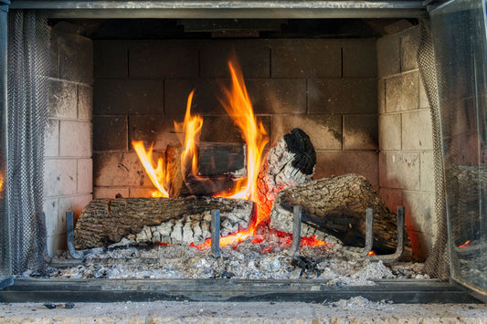 An open fire burning in a stone fireplace, The Meadow Spa at Thyme, Southrop