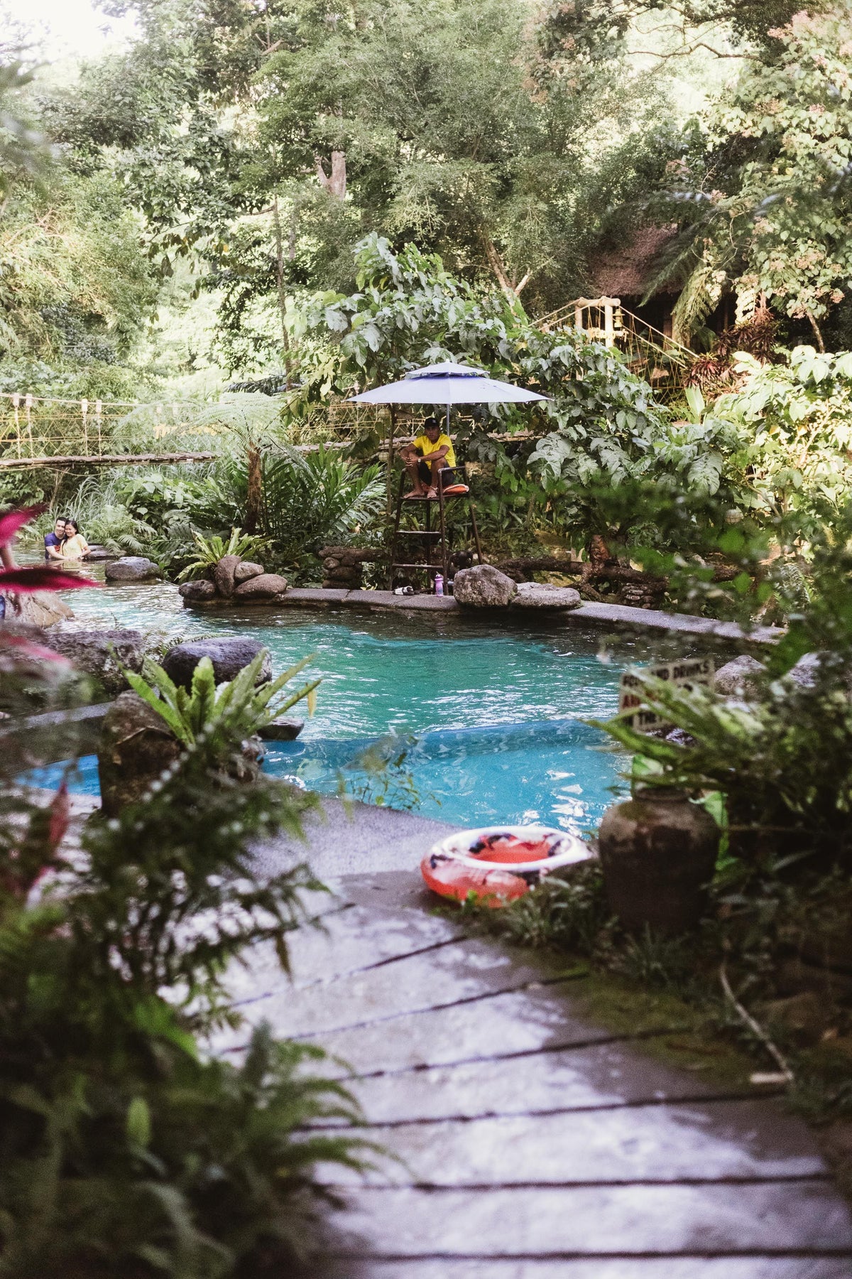 A pool set into lush green landscaped grounds