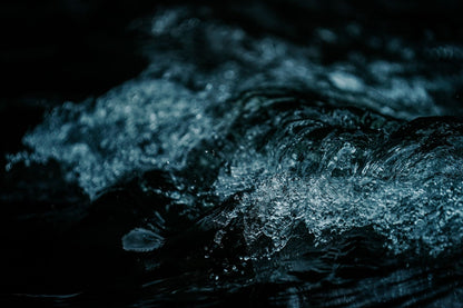 Dark water breaking into a cold wave, evoking the plunge after a warm vinotherapy ritual