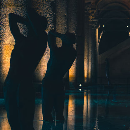 Stone columns lit low above still teal water, the feeling of the columned pool hall at Four Seasons London at Tower Bridge