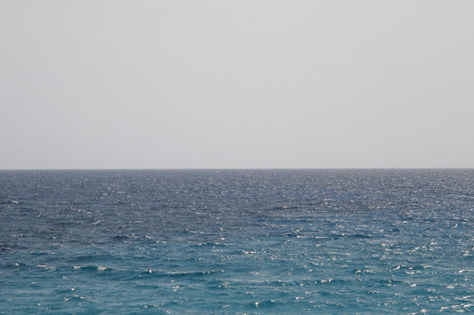 Calm grey green Mediterranean sea under soft morning light, evoking the view from a longevity clinic above the Costa Blanca