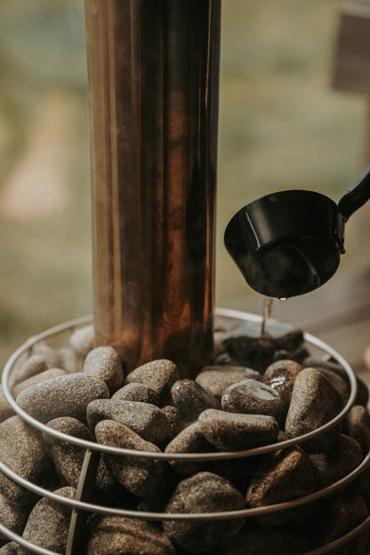 Water poured over hot sauna stones in a copper lined heater at a Rioja wine country spa