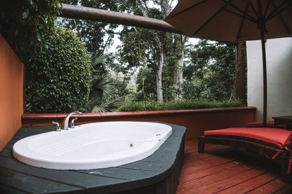 Outdoor jacuzzi terrace surrounded by lush greenery