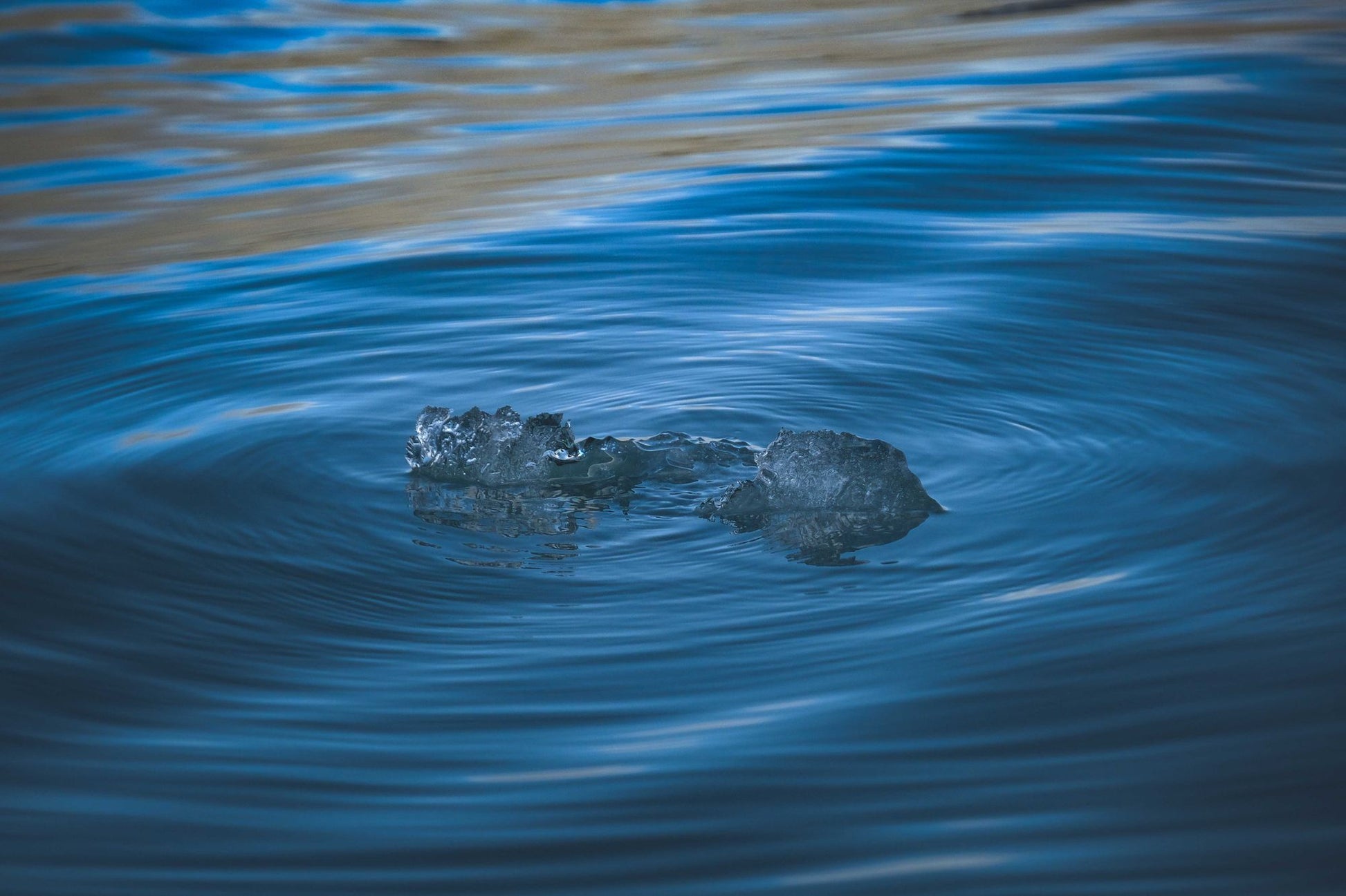 Ice melting into moving blue water, the ice bath at Asaya at The Chancery Rosewood
