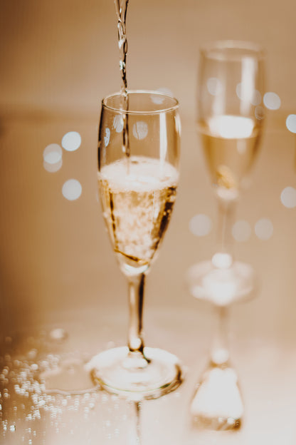 Champagne poured into a glass in warm low light, The Spa at Ellenborough Park, Cheltenham