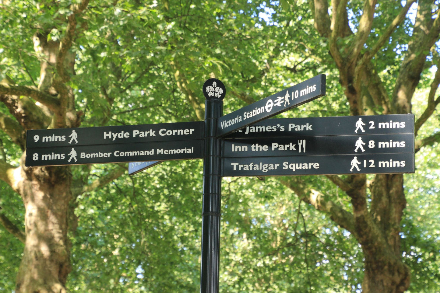 A park fingerpost pointing the way to Hyde Park Corner and St James's Park beneath the plane trees, The Lanesborough Club & Spa