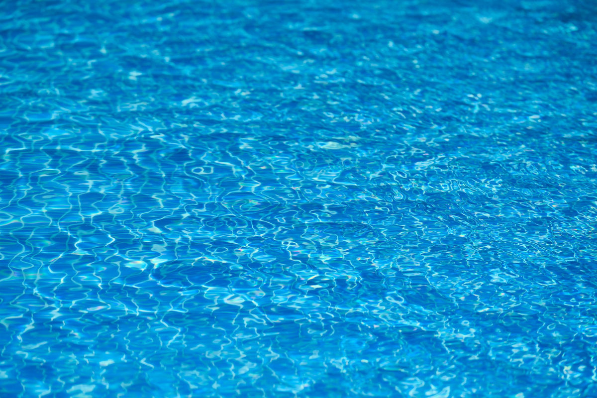 Rippled blue water catching the light, evoking the estate's cold plunge