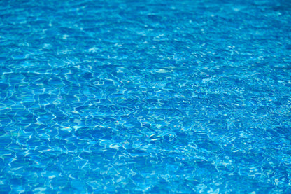 Rippled blue water catching the light, evoking the estate's cold plunge