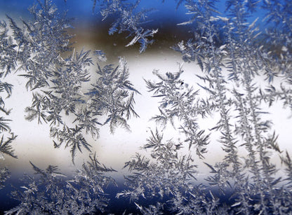 Delicate frost crystals on glass, echoing the cold end of the spa's thermal circuit.