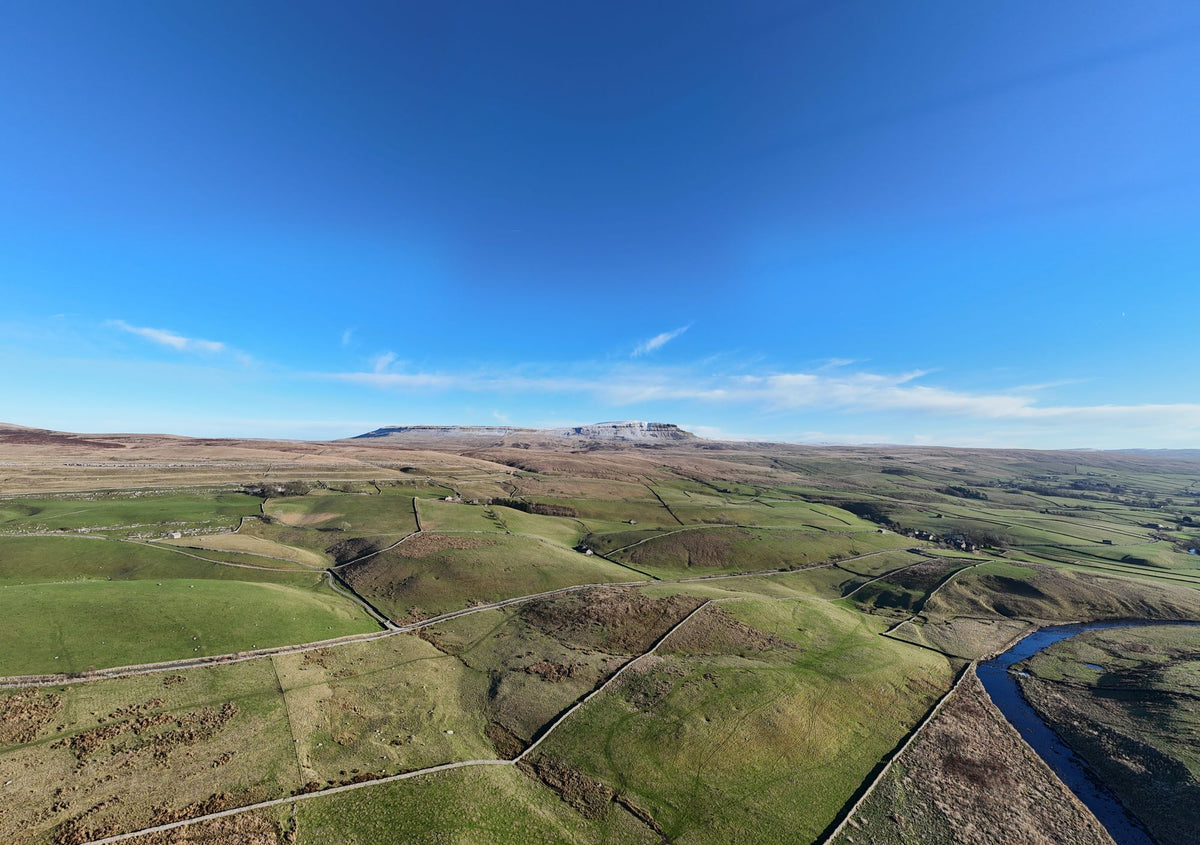 Aerial view of green Yorkshire Dales hillsides and the River Ure, evoking the riverside setting of Ure River Retreat