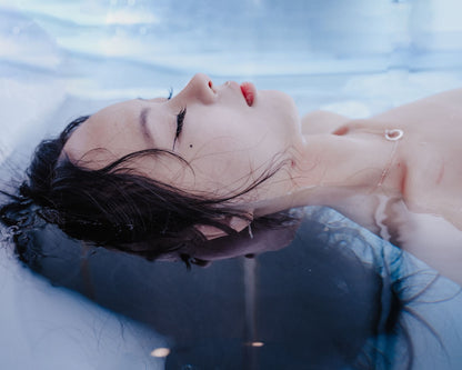 A woman floating on her back with her eyes closed, Surrenne at The Emory