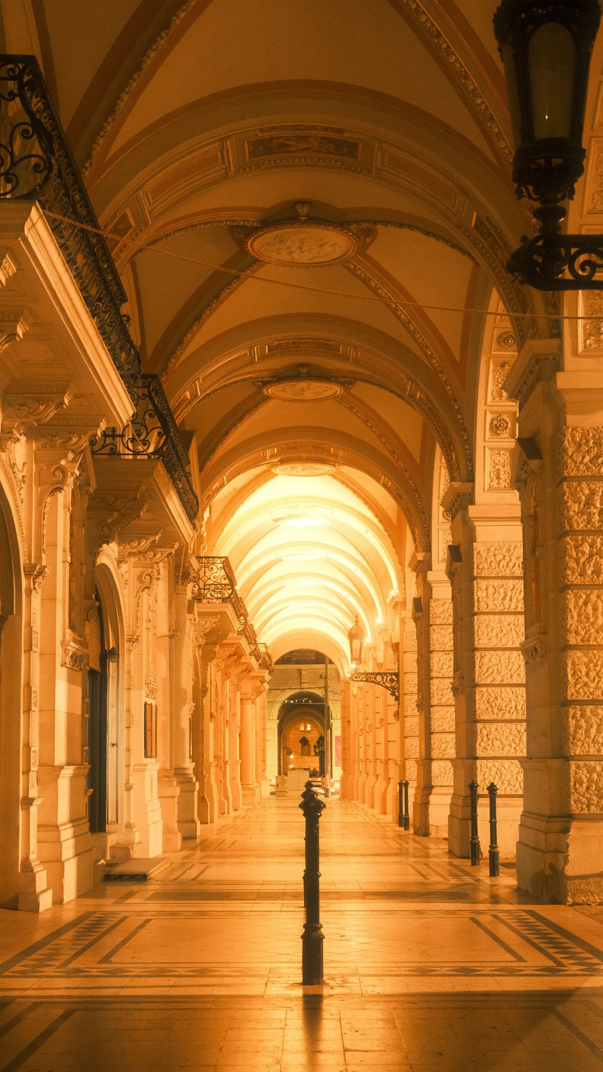 Golden lit vaulted stone archway evoking the historic character of The Cross Bath