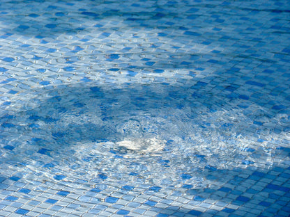Bubbles rising through tiled pool water, evoking the bubble experiences in the relaxation pool