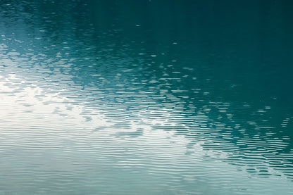 Still deep green water with a soft band of light laid across it, the surface of the 14 metre pool