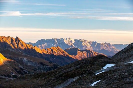 Dramatic golden light over Alpine peaks at sunrise near Merano, South Tyrol