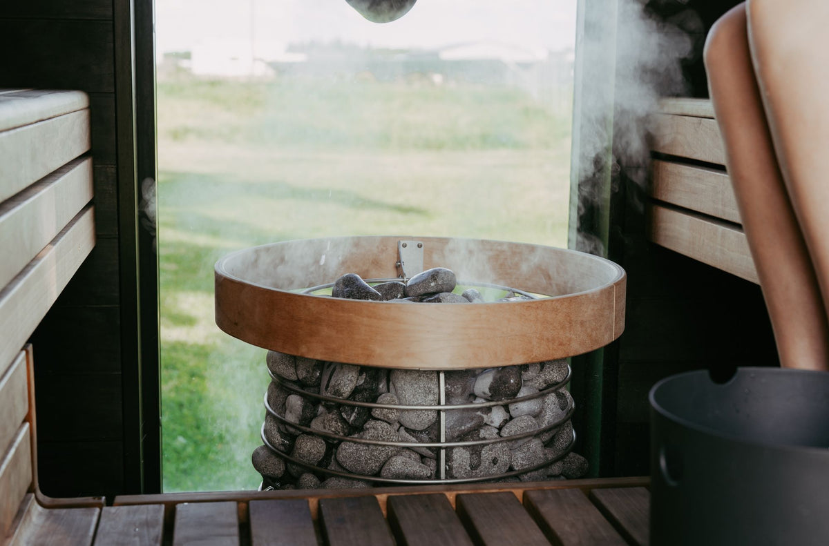 Steam rising from hot coals in a wood lined sauna