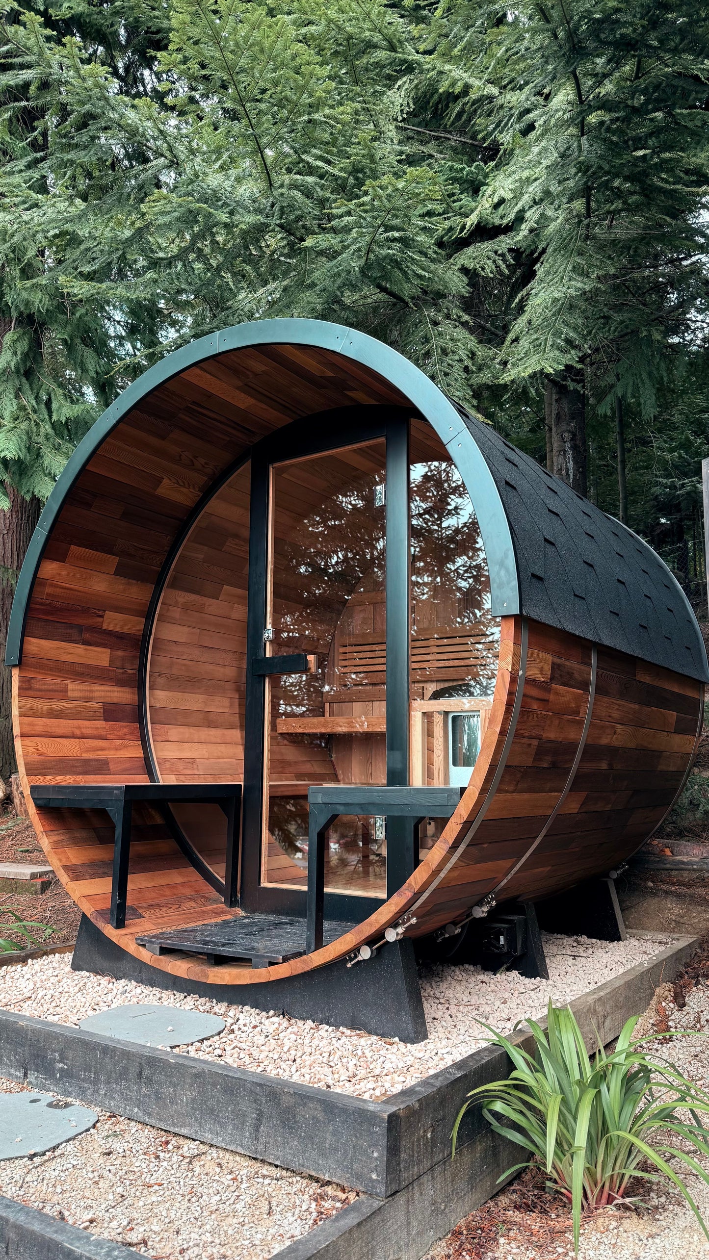 A wood fired barrel sauna set in a forest clearing, evocative of the private outdoor sauna and hot tub in Galgorm's own forest accommodation, Galgorm Thermal Spa Village, Ballymena