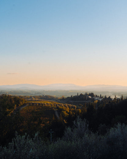 Soft golden light over the rolling Tuscan countryside at dusk