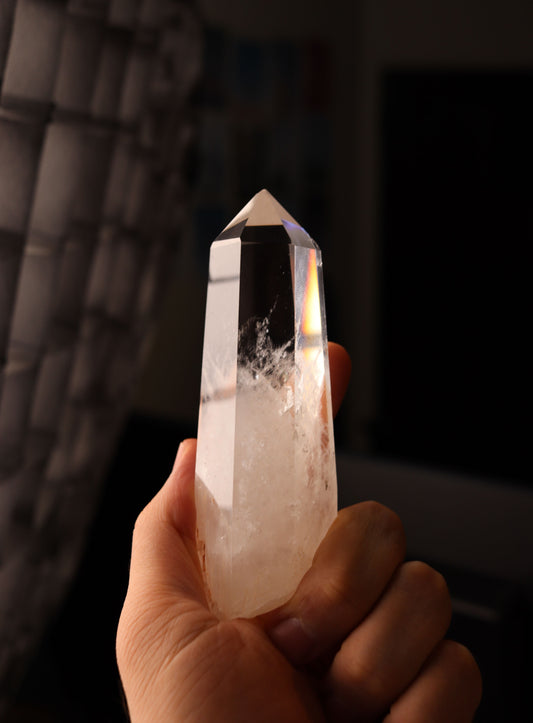 A clear quartz crystal held up to warm light, Bamford Wellness Spa, Daylesford