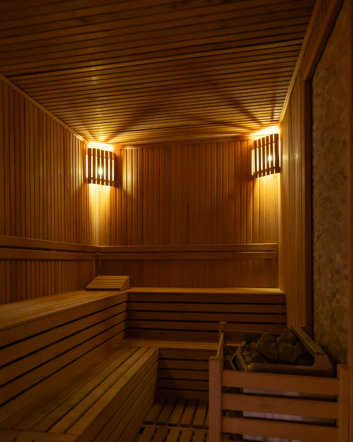 Warm wooden sauna interior with soft lamplight, part of a South Tyrol medical spa's thermal floor