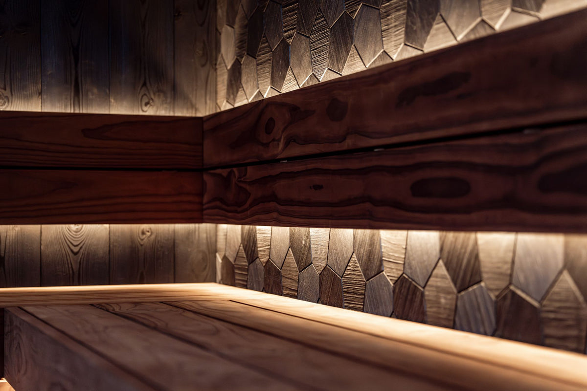 Warm lit cedar sauna corner at Carne Bay Spa at The Nare