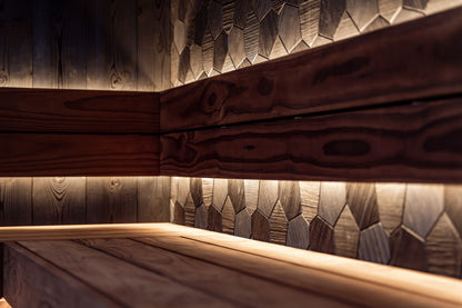 Warm lit cedar sauna corner at Carne Bay Spa at The Nare