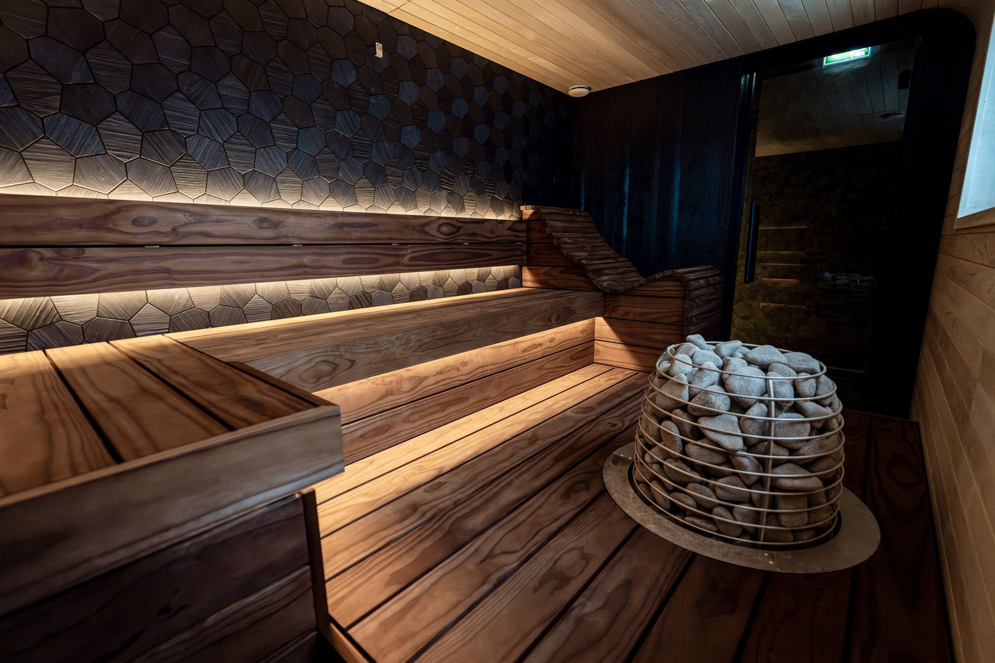 A wooden sauna interior glows with warm light.