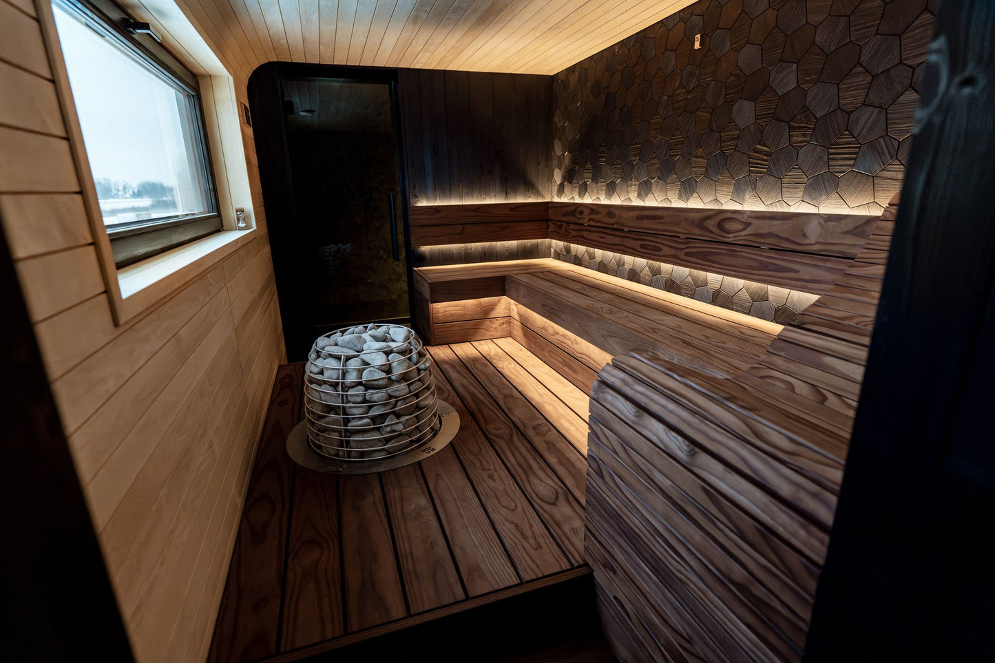 A warm wood lined sauna interior with soft lighting