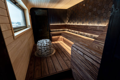 A warm wood lined sauna interior with soft lighting