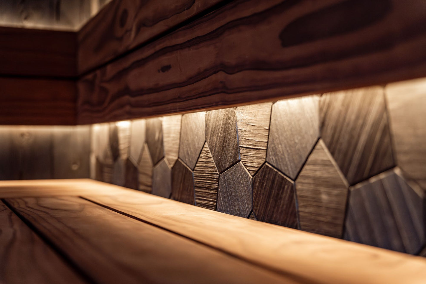 Warm cedar panelling lit low, evoking the infrared sauna in the Strong Rooms locker area