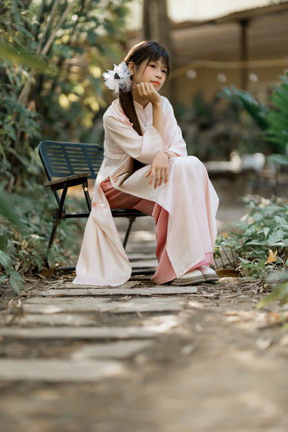 A woman in a soft robe sitting out in a garden in gentle daylight, Fieldhouse Spa at THE PIG in the Cotswolds