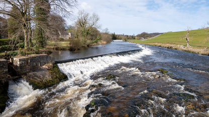 A stone weir on a river running through green hills, The Spa at Adare Manor, Adare
