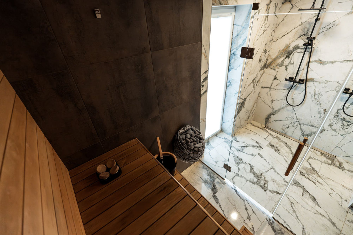 A modern sauna interior with marble and wood, evoking the heat side of the spa