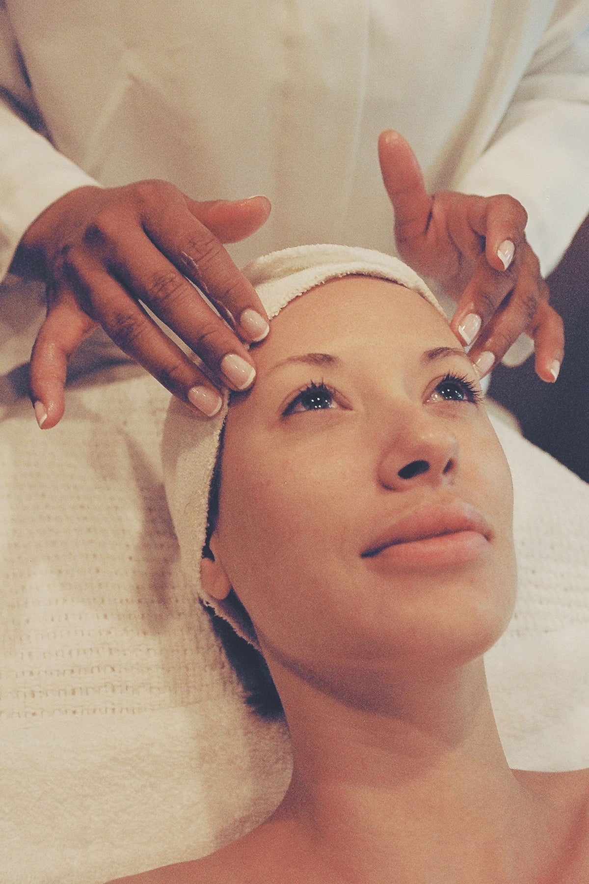A therapist's hands during a facial treatment at Spa La Mer.