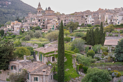 A terraced hillside village with cypress trees, evoking the gardens above Portofino Bay