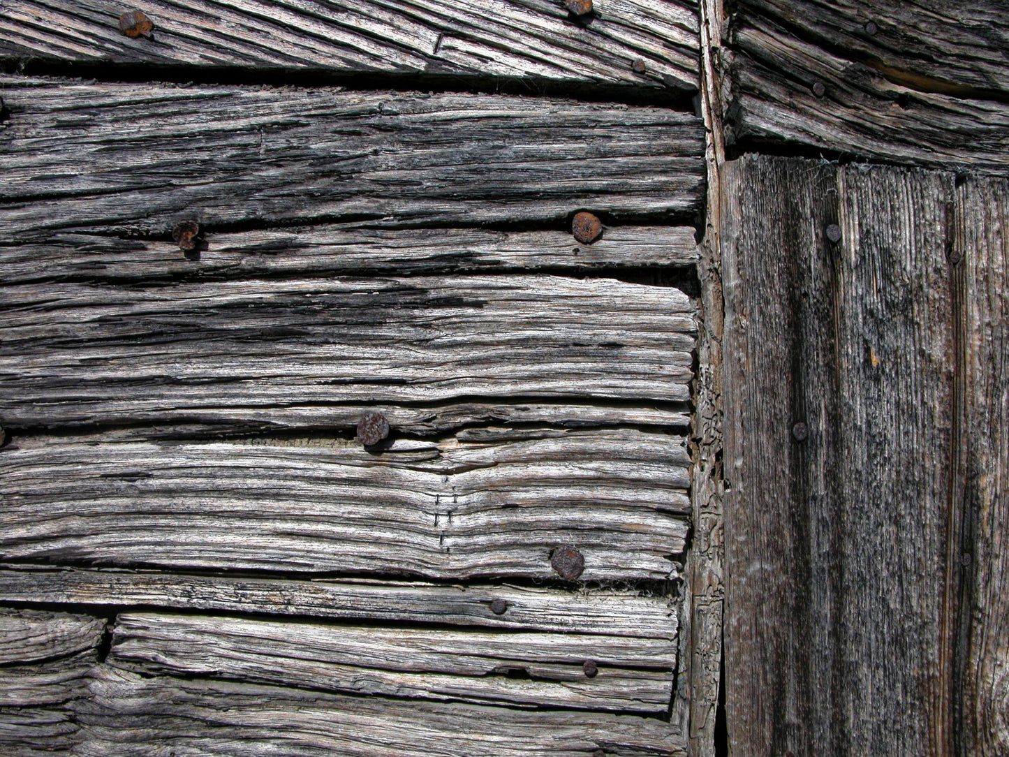 Close detail of weathered timber, evoking the estate original farm buildings