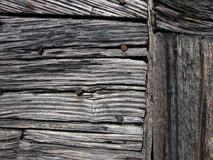 Close detail of weathered timber, evoking the estate original farm buildings
