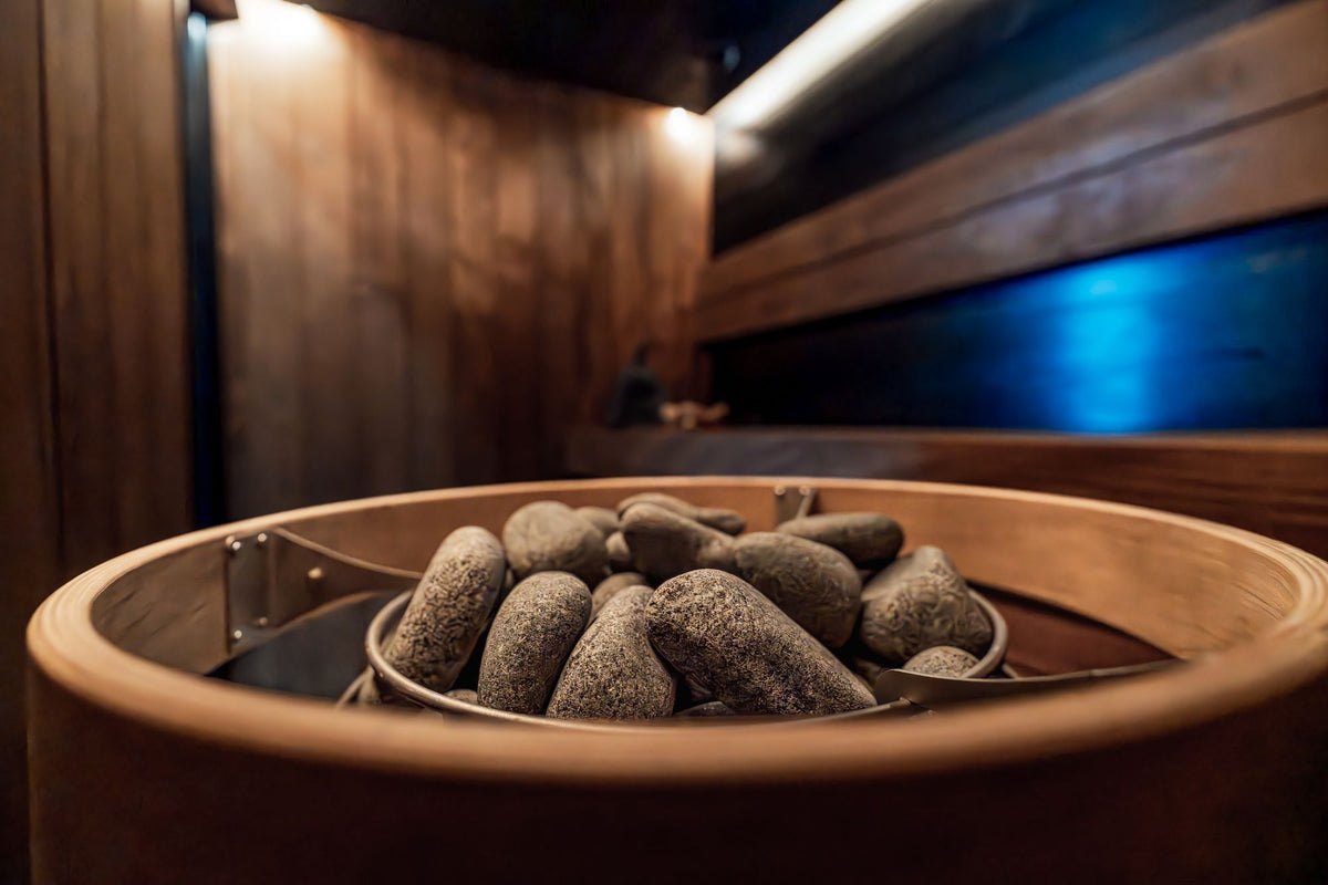 A dark timbered sauna interior with hot stones and low blue light, Galgorm Thermal Spa Village, Ballymena