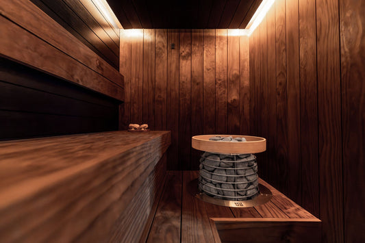 Warm, wood panelled sauna interior with a traditional heater at Rockliffe