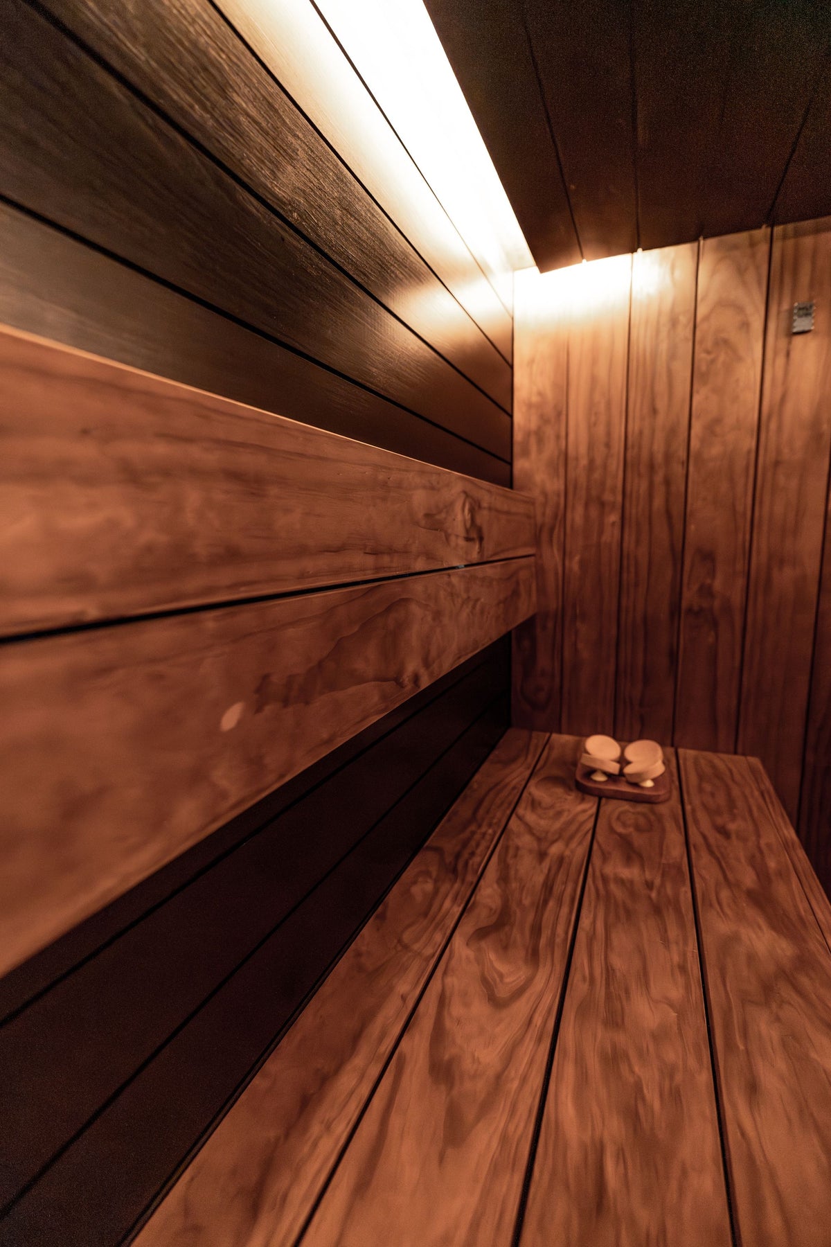 Warm wood panelled sauna with soft strip lighting at The Bath House Spa, Royal Crescent