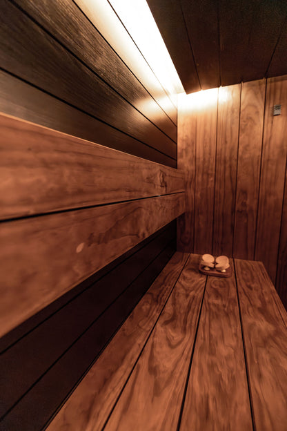 Warm wood panelled sauna with soft strip lighting at The Bath House Spa, Royal Crescent
